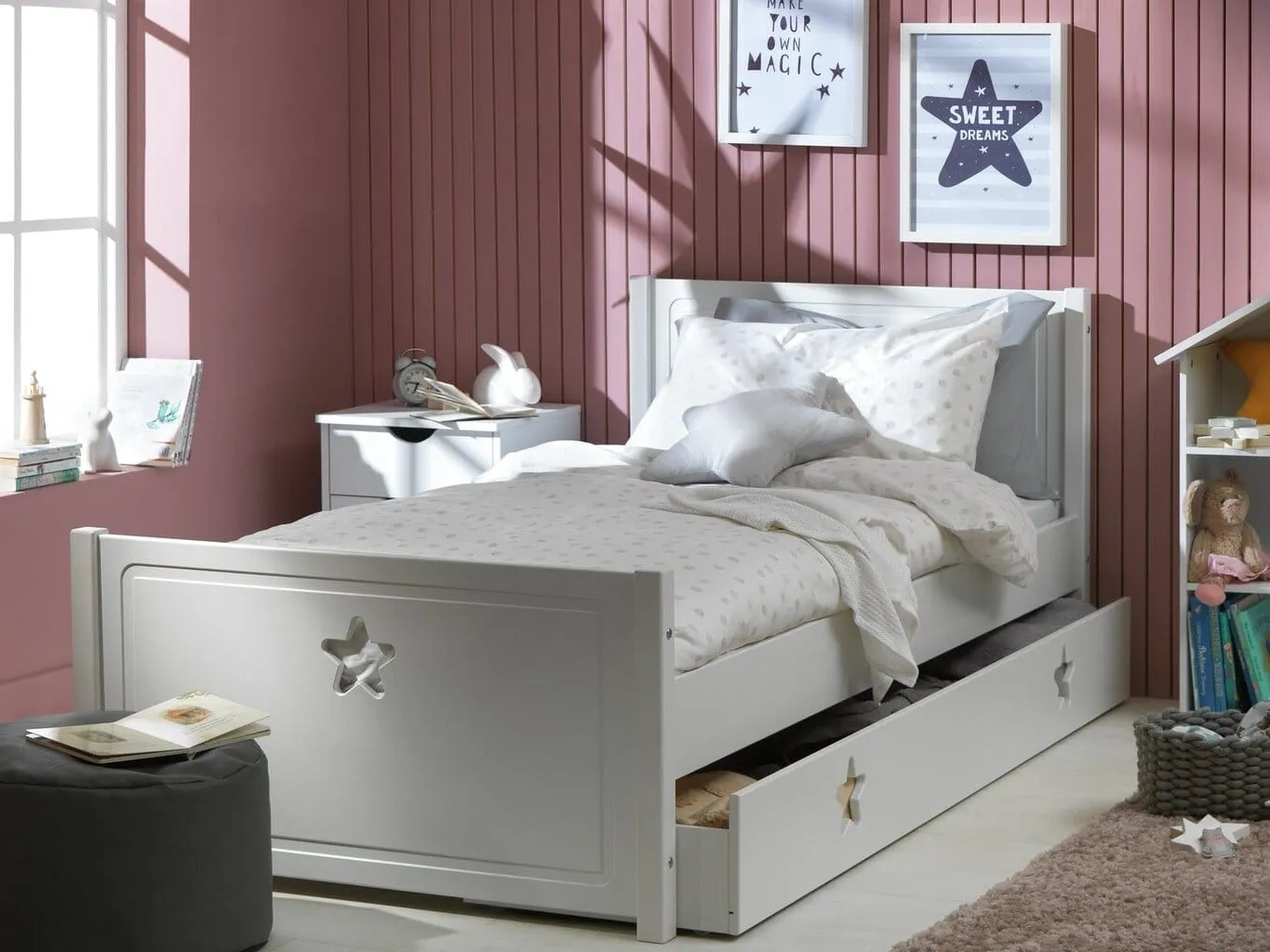 White-painted bed frame with star motif