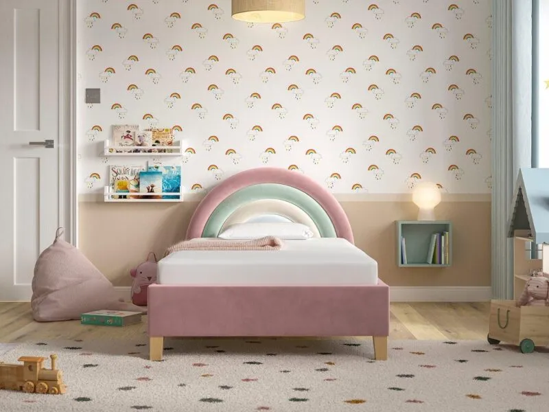 Pink fabric upholstered bed frame with rainbow headboard