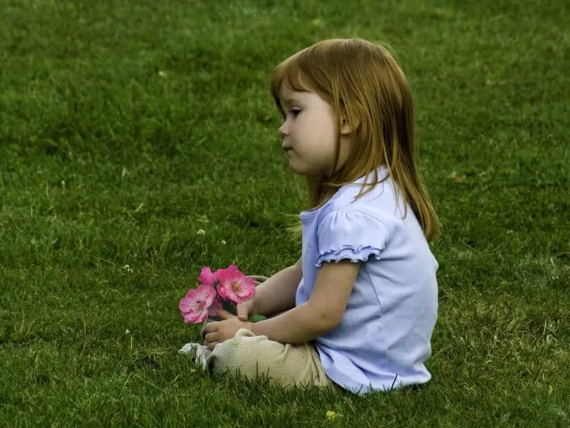 Young girl sitting on the lawn